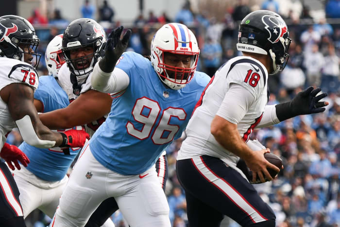 Dec 17, 2023; Nashville, Tennessee, USA; Houston Texans quarterback Case Keenum (18) is sacked by Tennessee Titans defensive end Denico Autry (96) during the second half at Nissan Stadium.